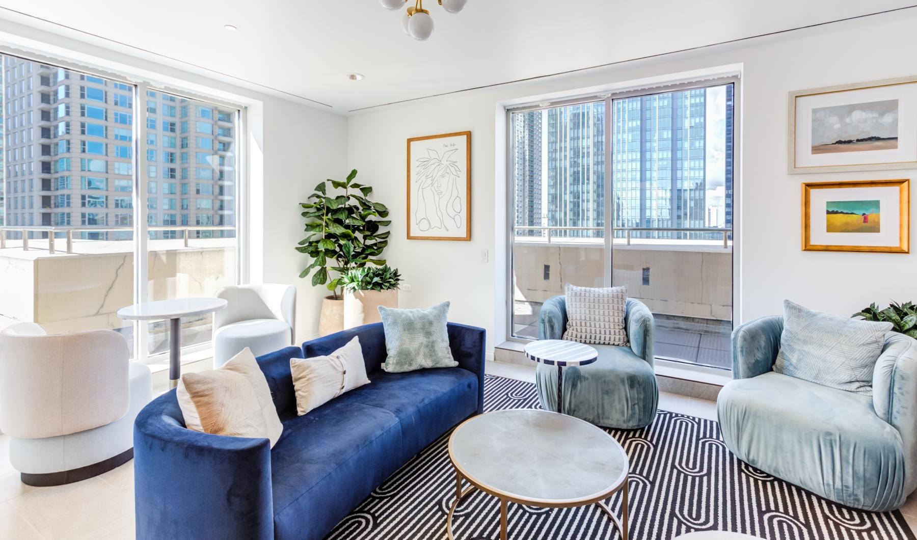 Settle into comfort at The Bernardin Apartments a living room with blue couches